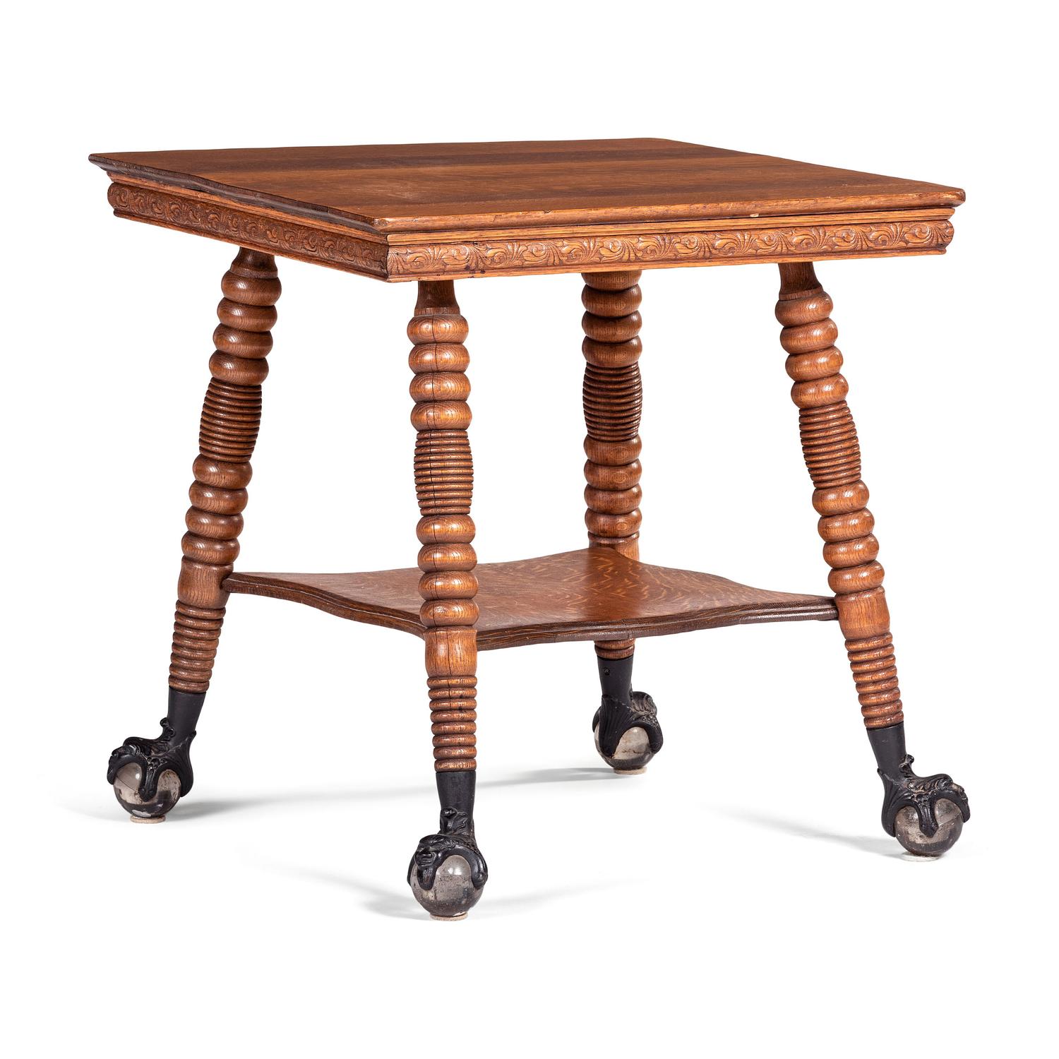A Victorian Center Table in Oak with Glass Ball and Claw Feet