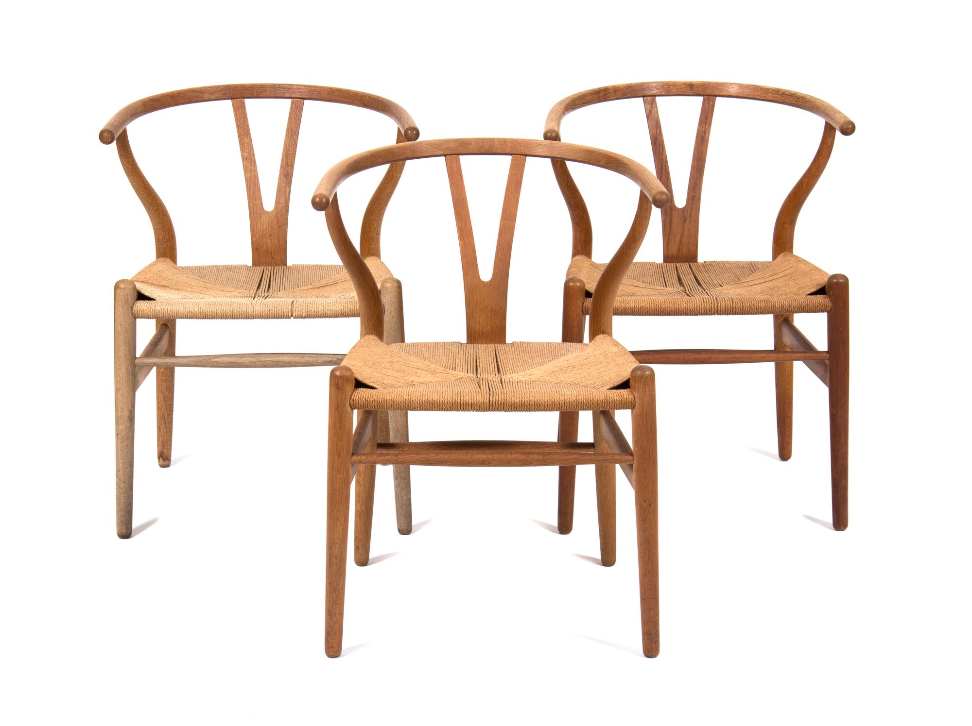 Three Hans Wegner Oak Armchairs Height 28 3/4 inches. — 20TH CENTURY