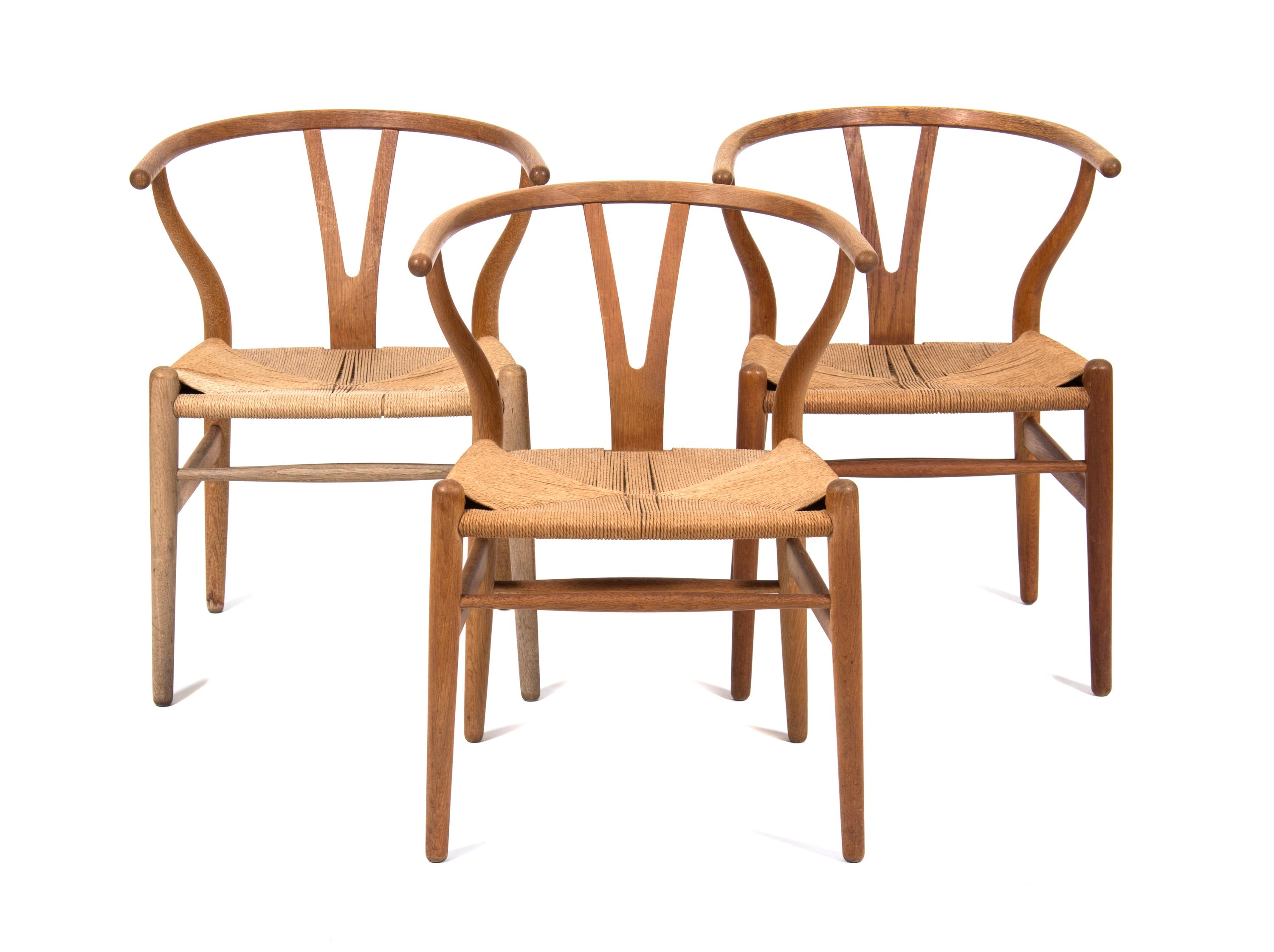 Three Hans Wegner Oak Armchairs Height 28 3/4 inches. — 20TH CENTURY