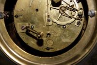 An Empire Style Gilt and Patinated Bronze and Marble Clock Garniture