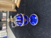 A 14 Karat Vari-Color Gold, Guilloché Enamel, Diamond, and Cabochon Jewel-Mounted Egg-Form Perfume and a Related Guilloché Enamel, 14 Karat Vari-Color Gold, Diamond, and Cabochon-Mounted Surprise Egg