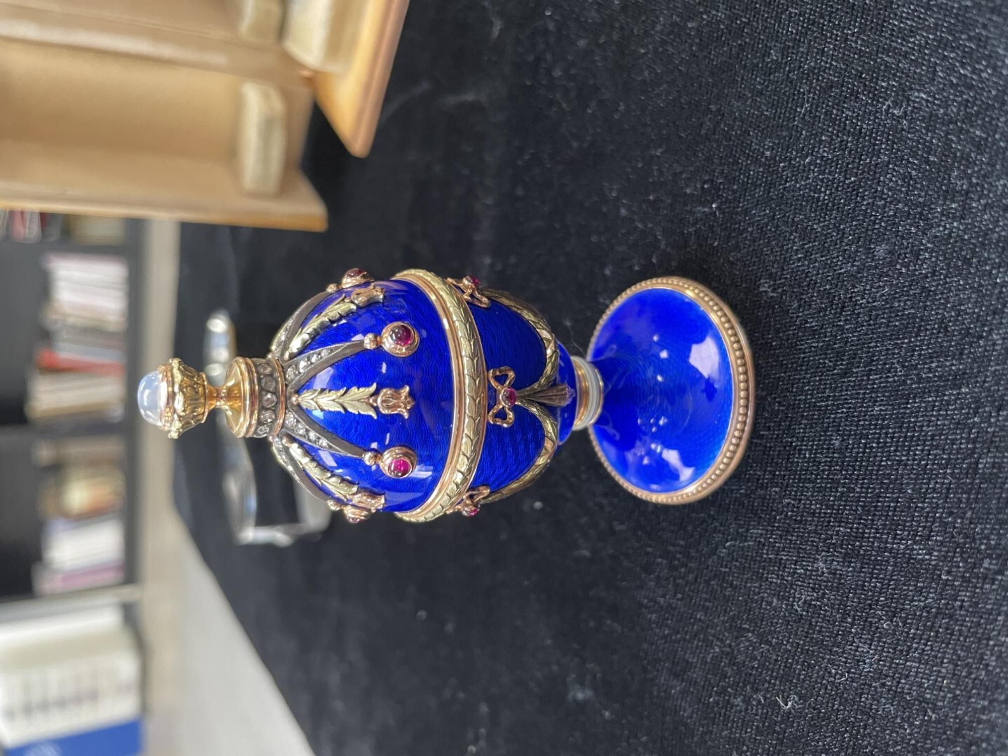 A 14 Karat Vari-Color Gold, Guilloché Enamel, Diamond, and Cabochon Jewel-Mounted Egg-Form Perfume and a Related Guilloché Enamel, 14 Karat Vari-Color Gold, Diamond, and Cabochon-Mounted Surprise Egg