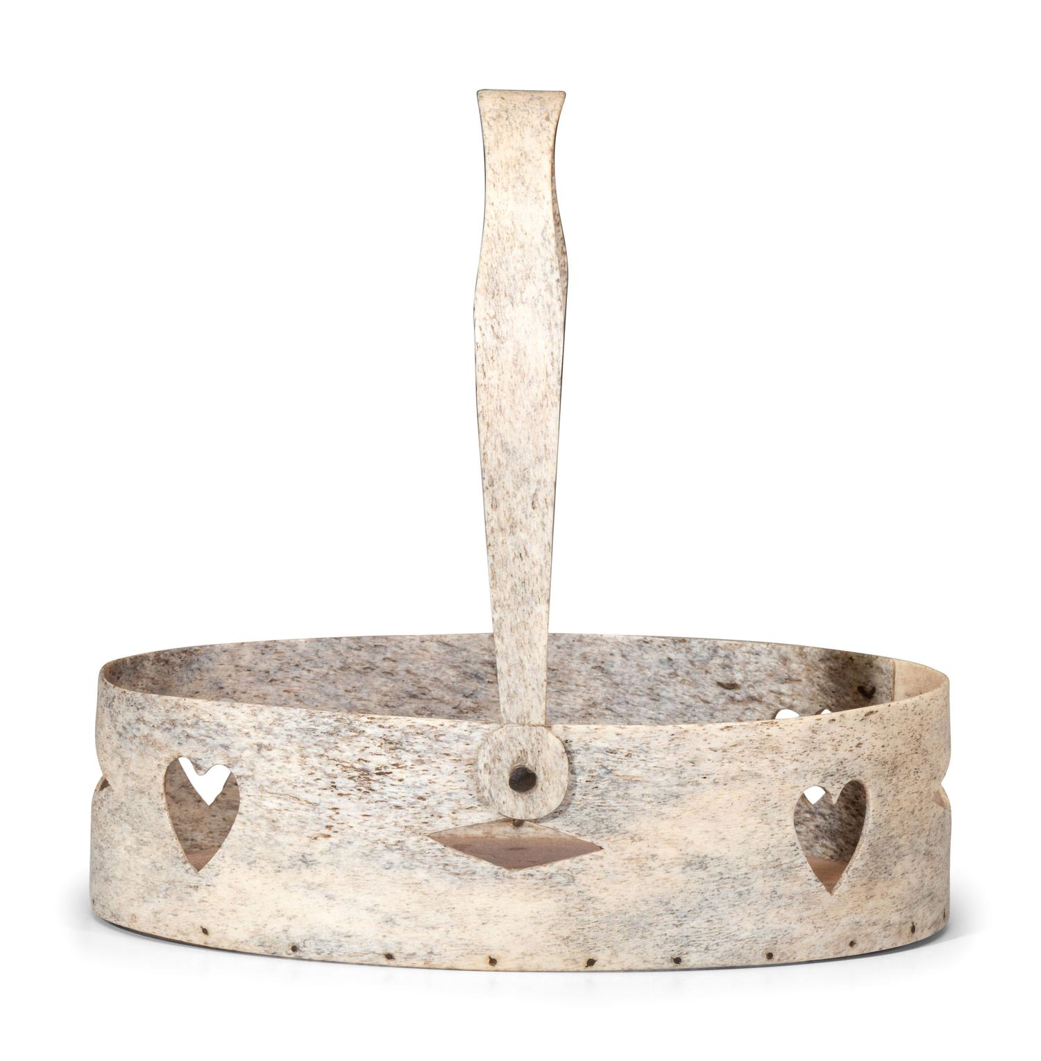 A Carved and Pierced Whale Bone Swing-Handle Basket