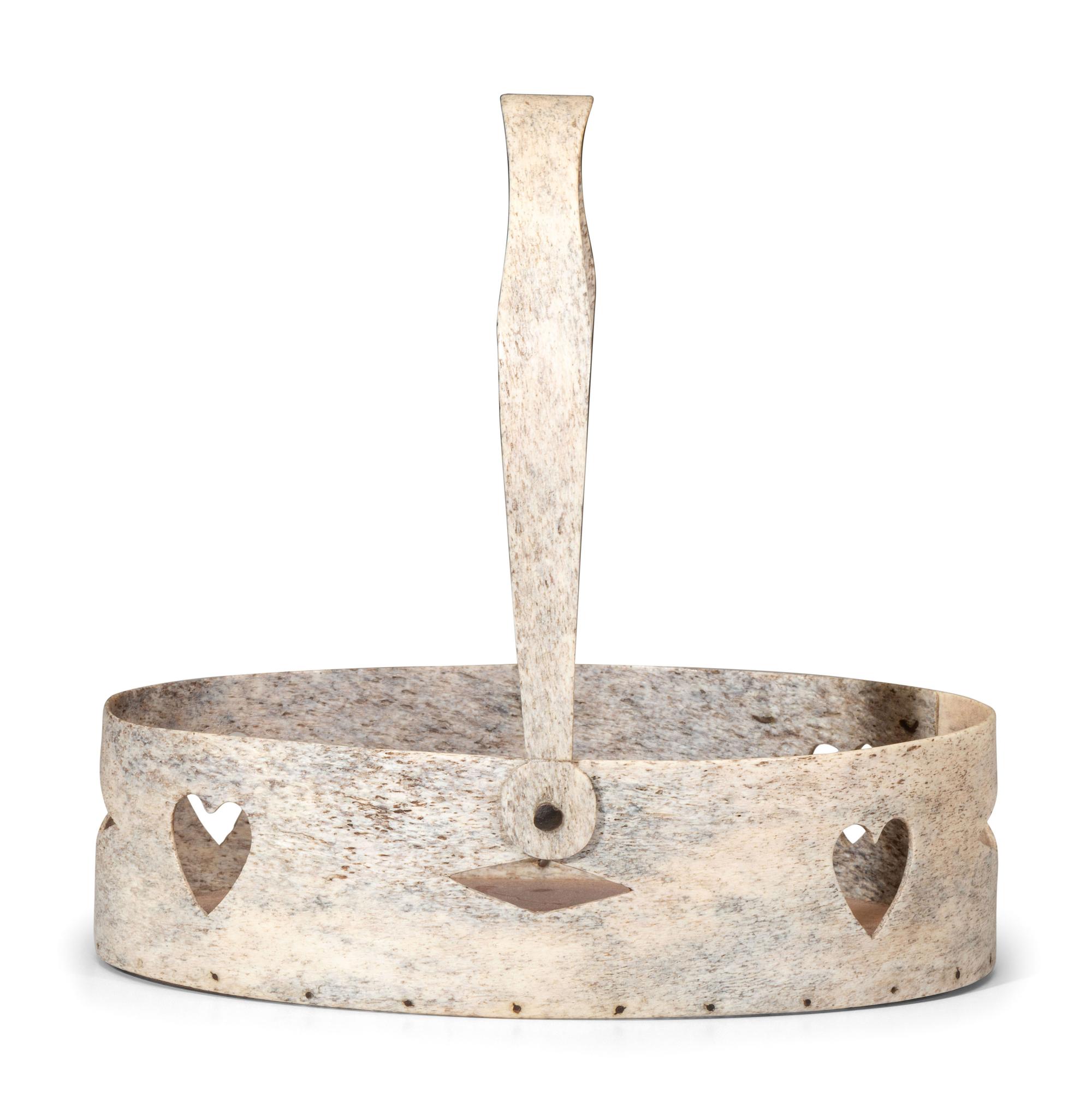 A Carved and Pierced Whale Bone Swing-Handle Basket