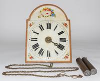 A Dutch Painted Wall Clock. Length 13 1/2 inches.