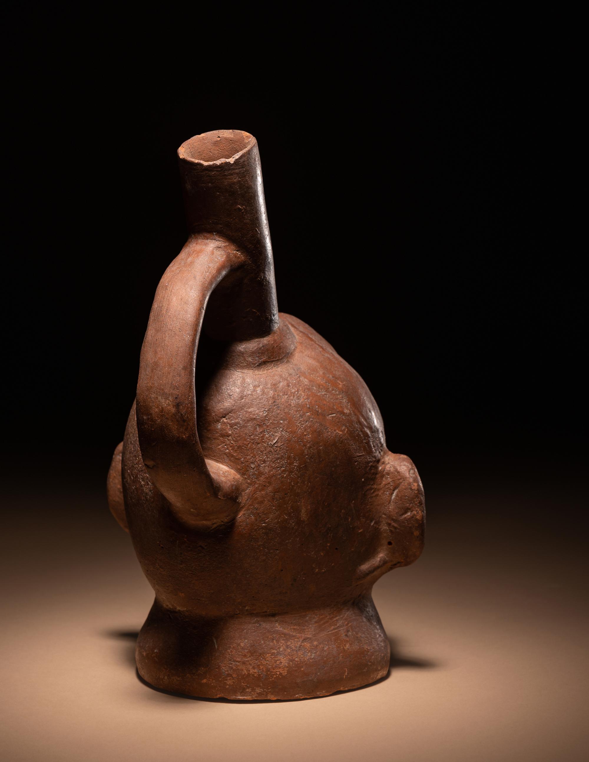 A Moche Warrior Face Stirrup Vessel
