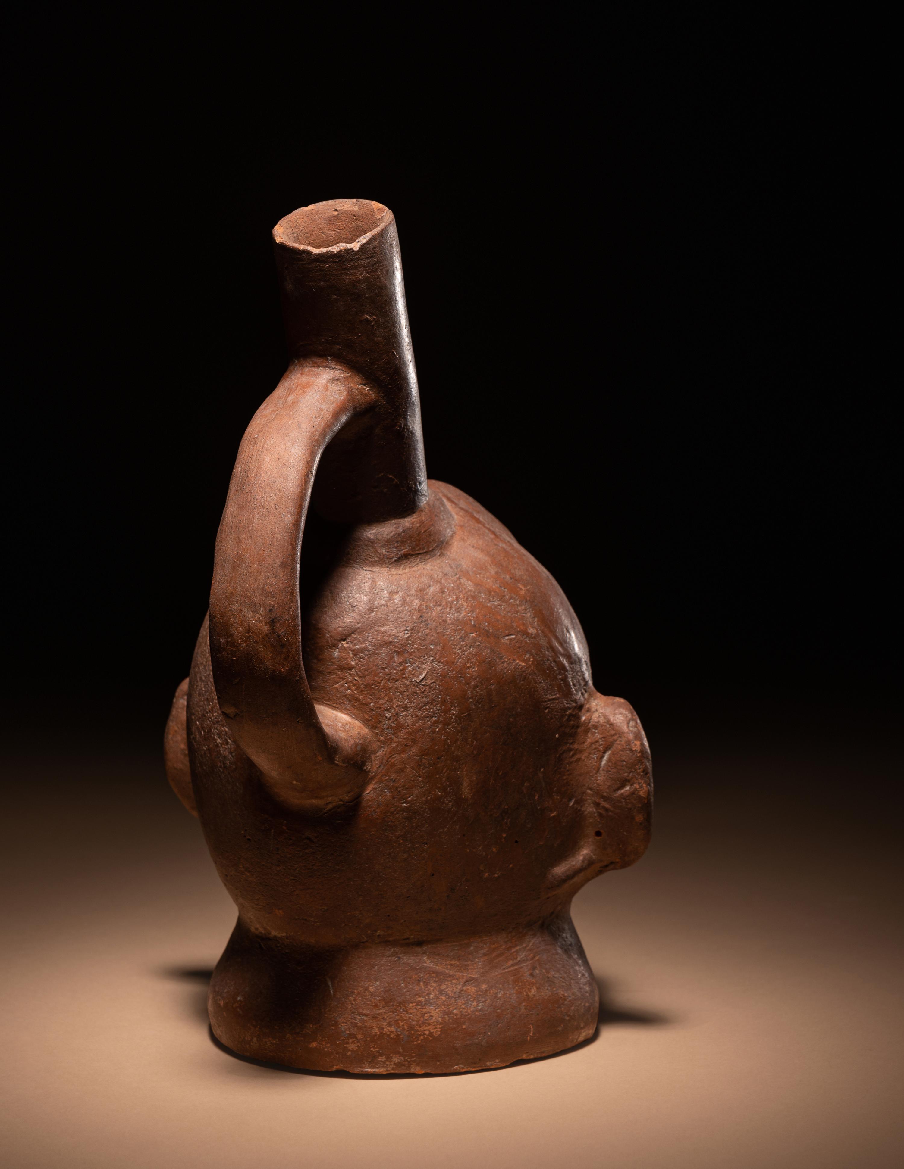 A Moche Warrior Face Stirrup Vessel