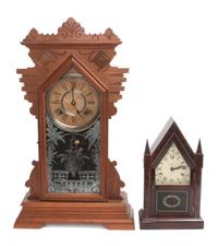 An American Walnut Gingerbread Clock, Ansonia Height of first 22 3/4 inches. — 19TH CENTURY