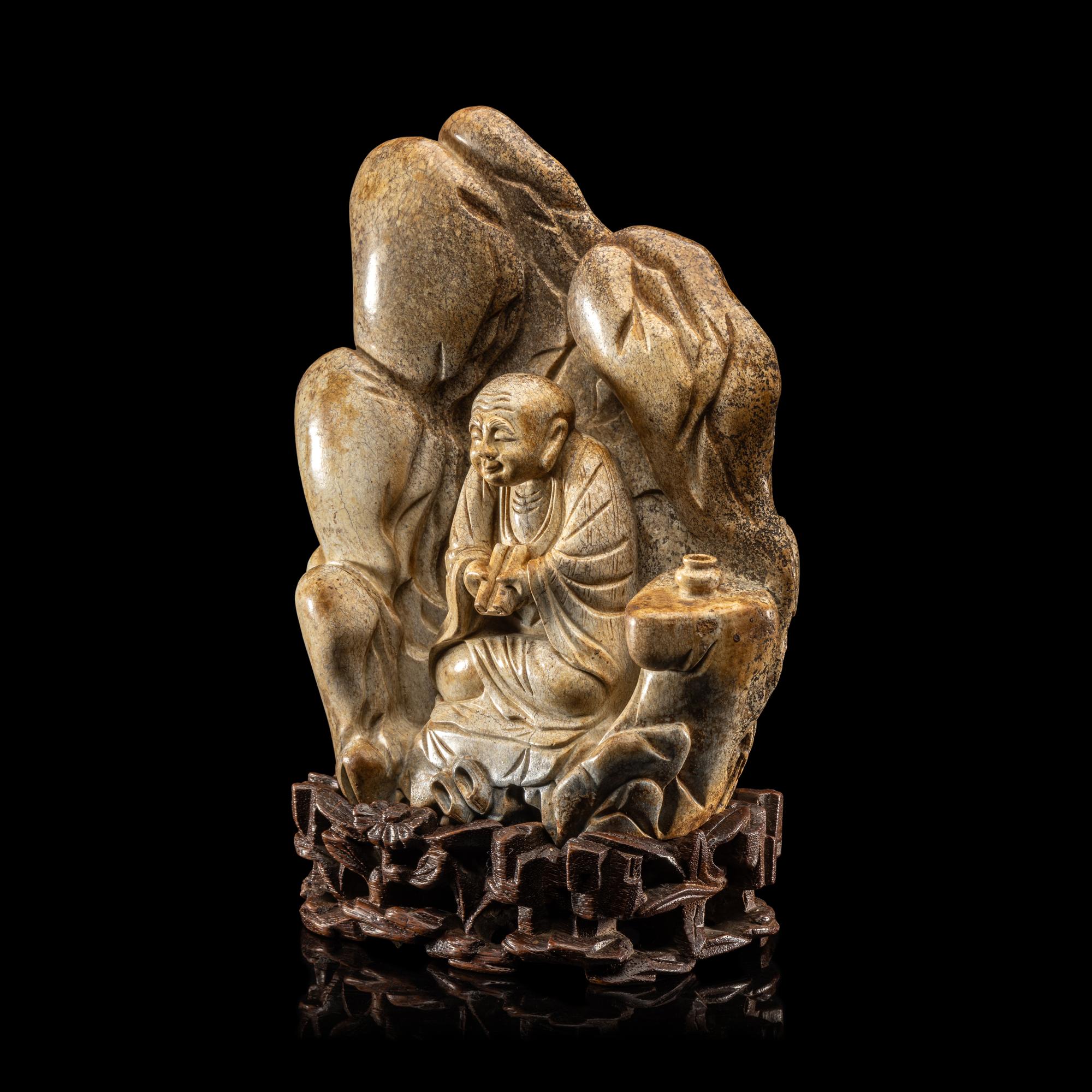 A Chinese Burnt Jade 'Luohan' Boulder 火燒玉羅漢山子