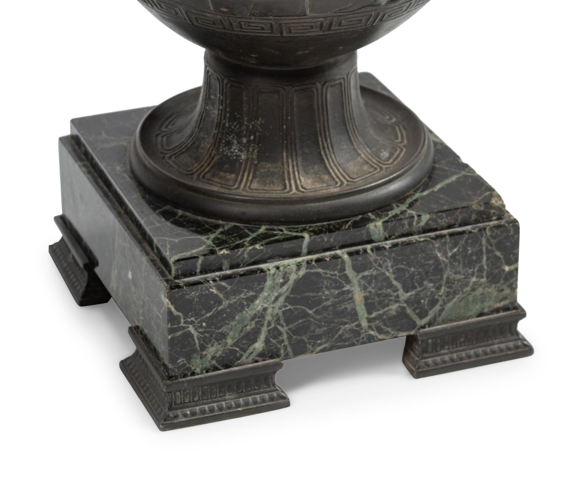 A Pair of Grand Tour Patinated Metal Urns on Marble Bases