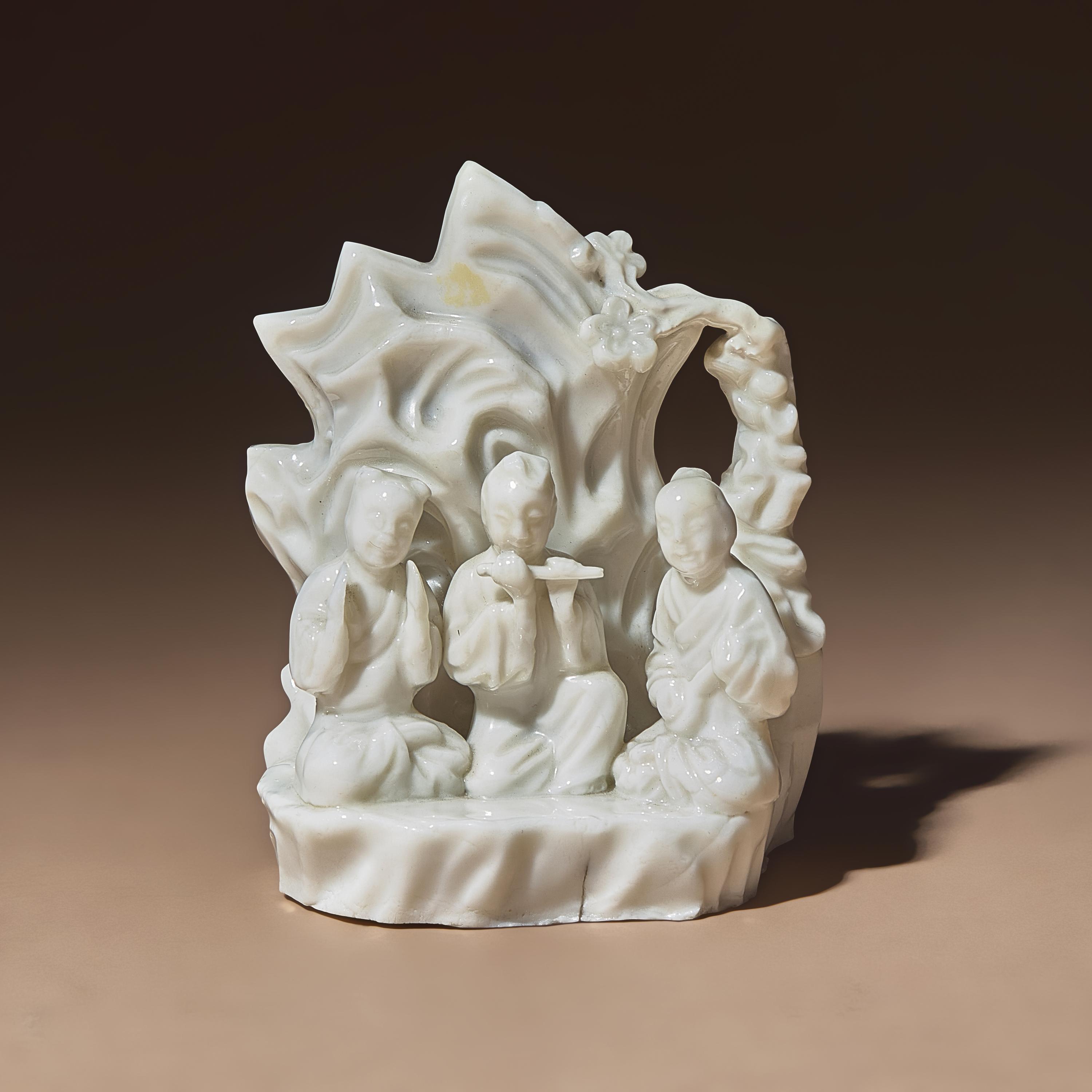 A Chinese Blanc-de-Chine Porcelain Figural Group of Three Musicians, 18th Century — 清中期 德化白瓷塑吹奏圖山子