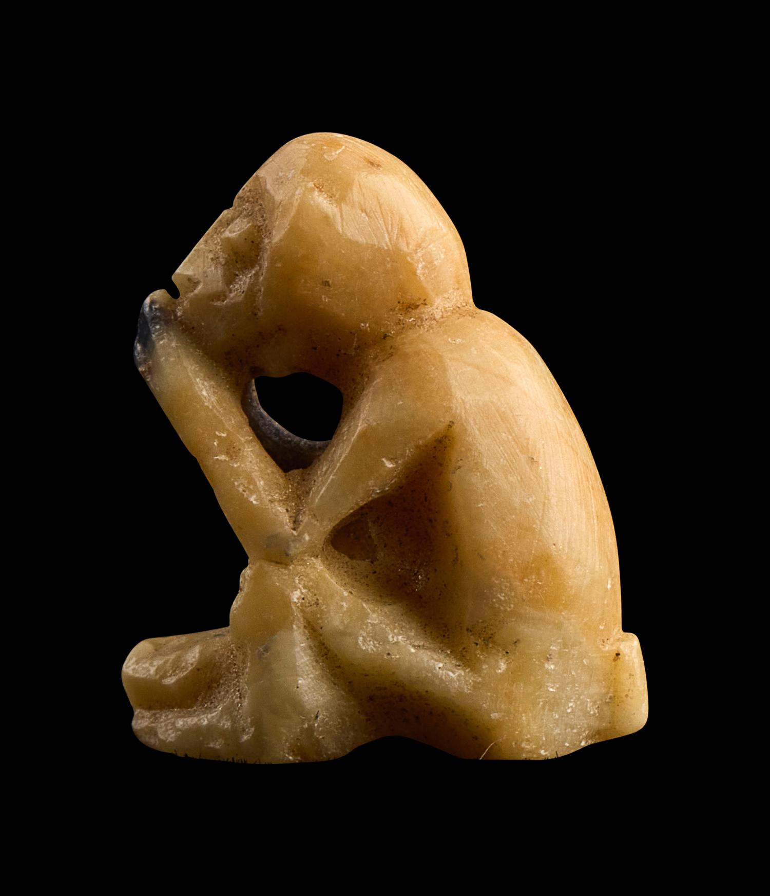 An Egyptian Carved Bone Monkey