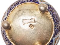An Assembled Set of Seven Silver and Enameled Salt Cellars with Spoons