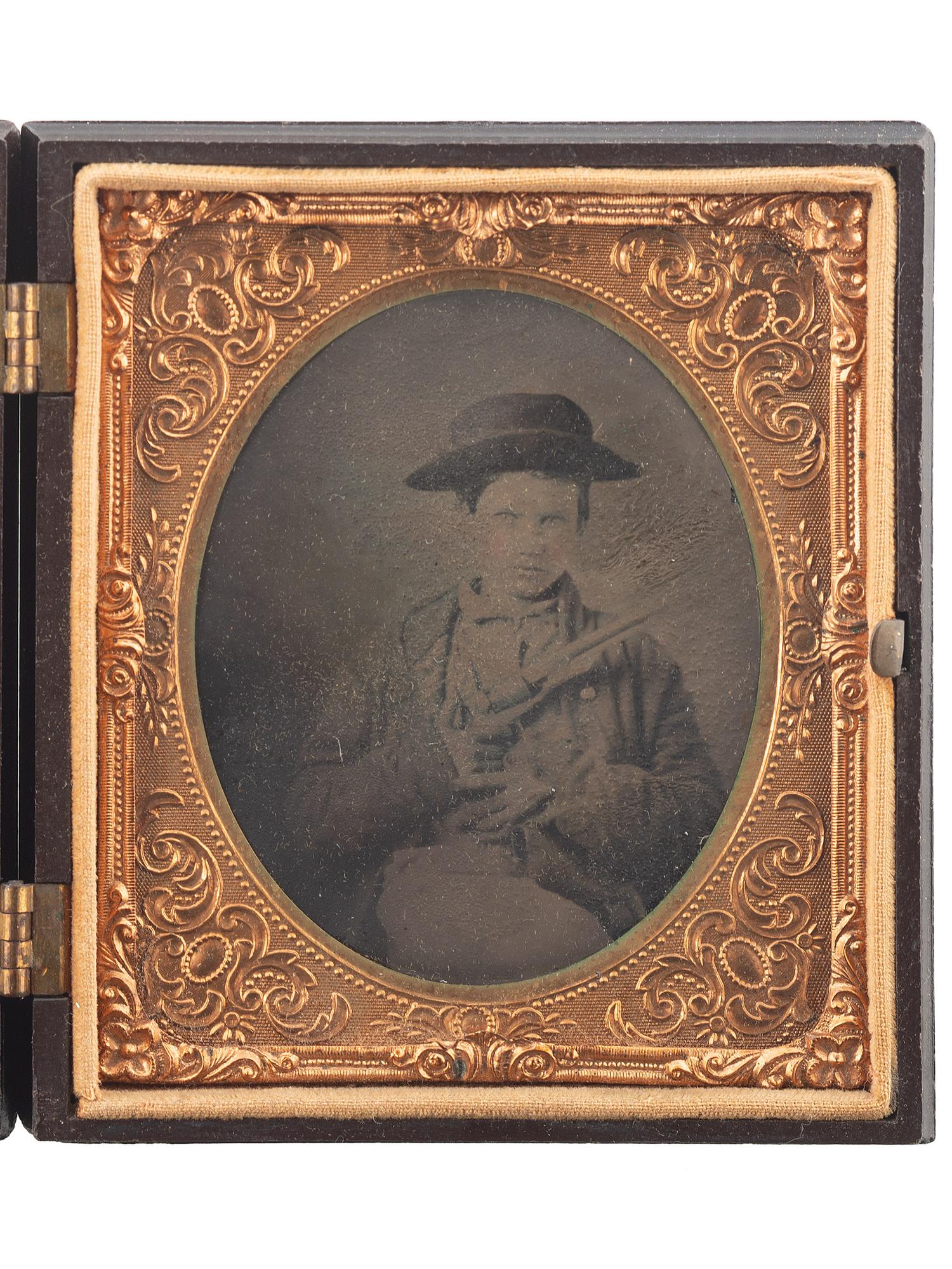 [EARLY PHOTOGRAPHY]. Sixth plate tintype of young boy armed with Model 1860 Colt Army revolver.