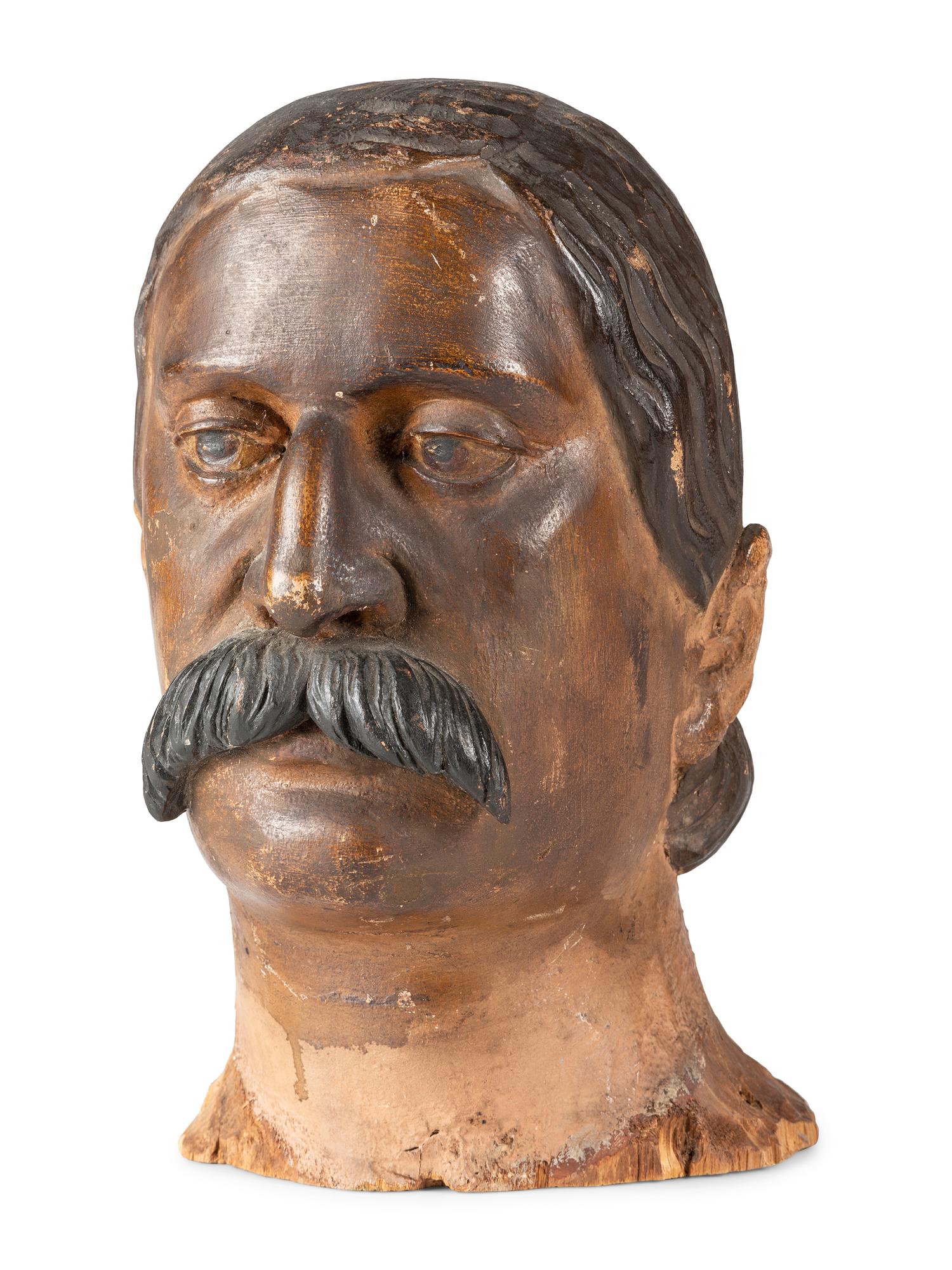 A Carved and Painted Wood Head of a Mustachioed Man