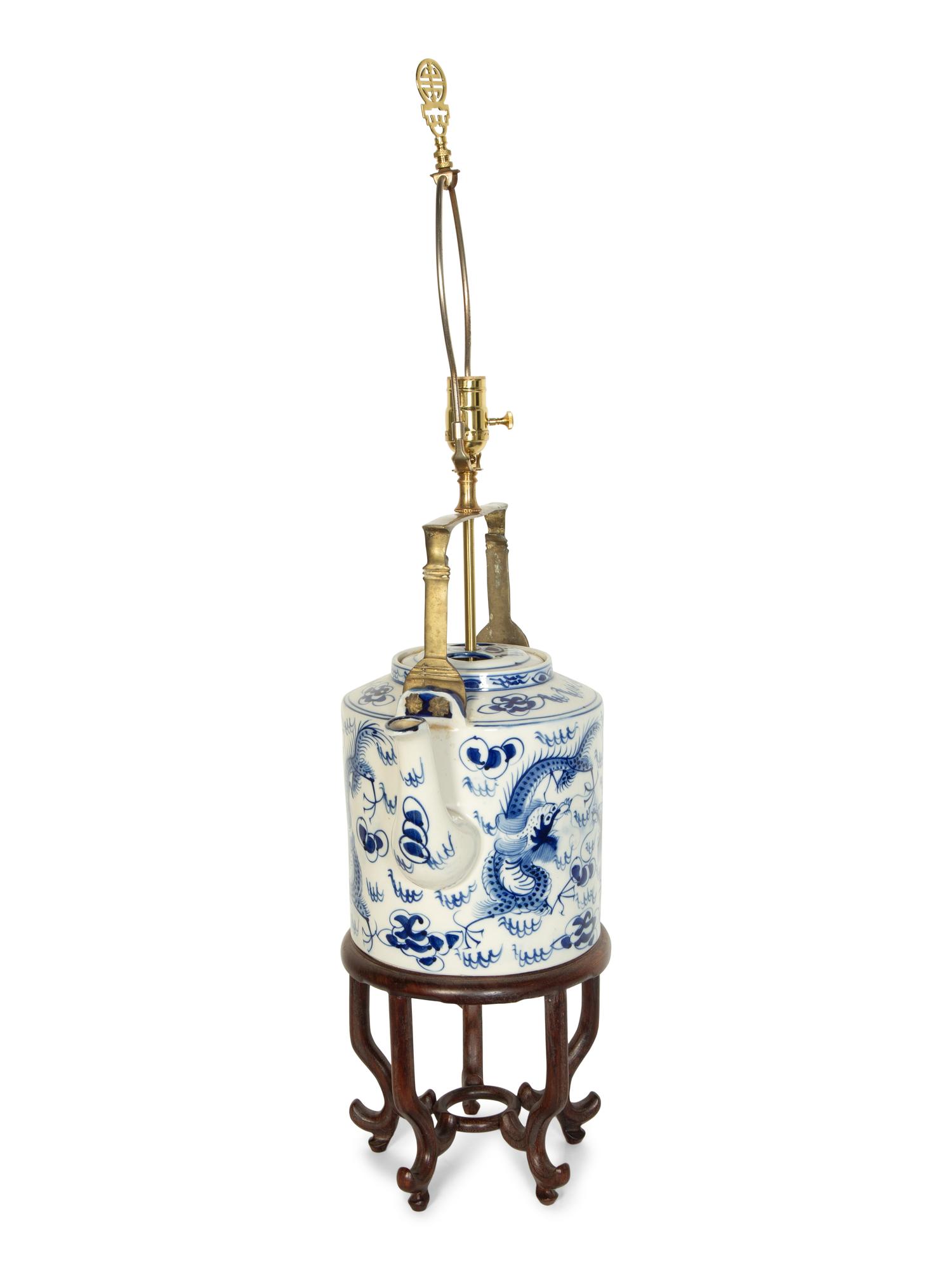 An Oversized Chinese Export Porcelain Teapot Mounted as a Lamp with a Wood Stand