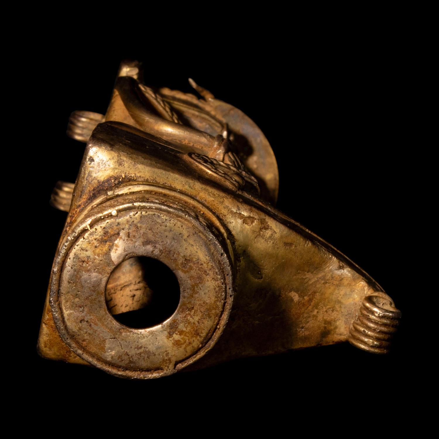 A Tairona Tumbaga Finial with a Shaman atop a Bird