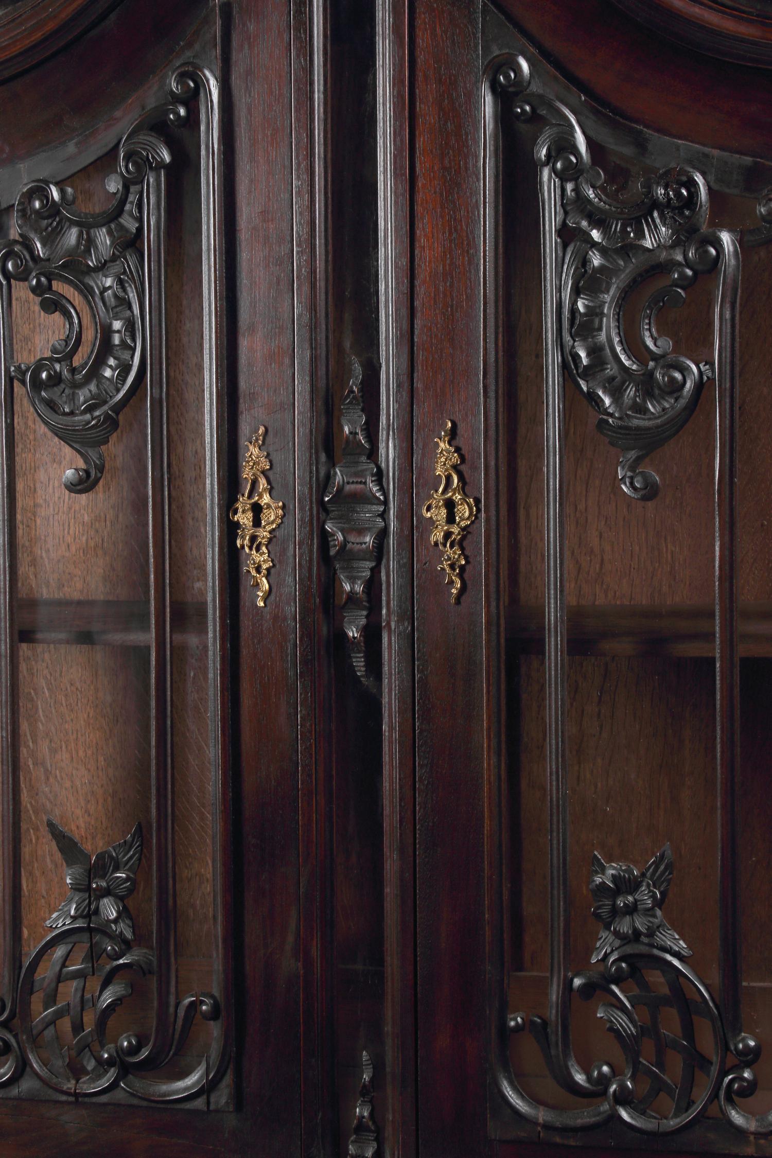 A Pair of Continental Rococo Style Carved Mahogany Vitrine Cabinets