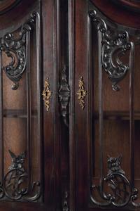A Pair of Continental Rococo Style Carved Mahogany Vitrine Cabinets