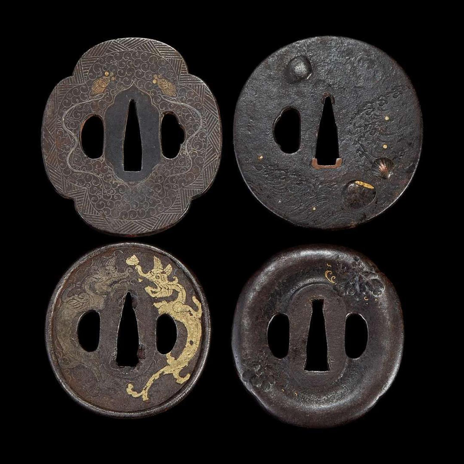 Group of eight Japanese inlaid iron tsuba Edo period or earlier