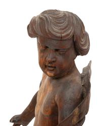 An Italian Carved Walnut Figure of Putto