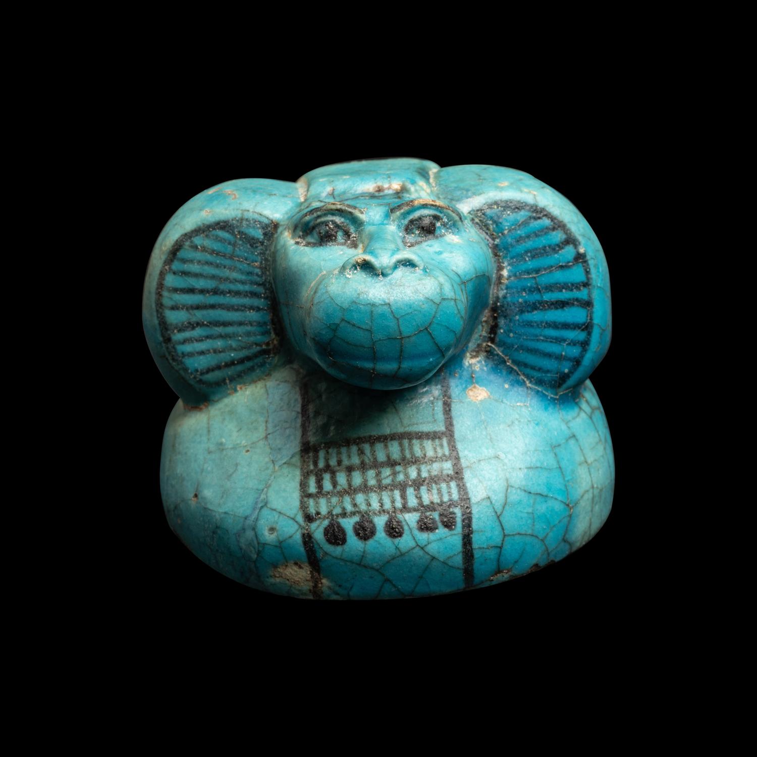 An Egyptian Blue Faience Canopic Jar Lid with the Head of a Baboon (Hapi)