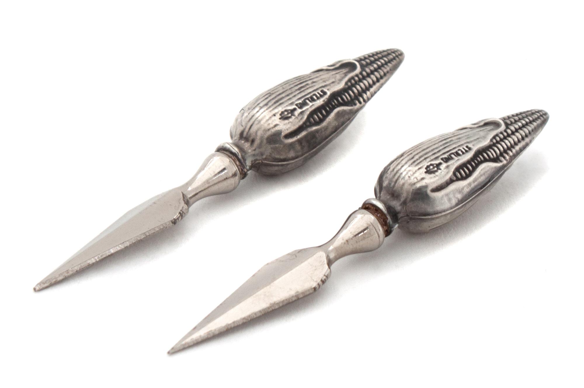 A Collection of Twenty Four Silver Corn Holders Length 3 inches.