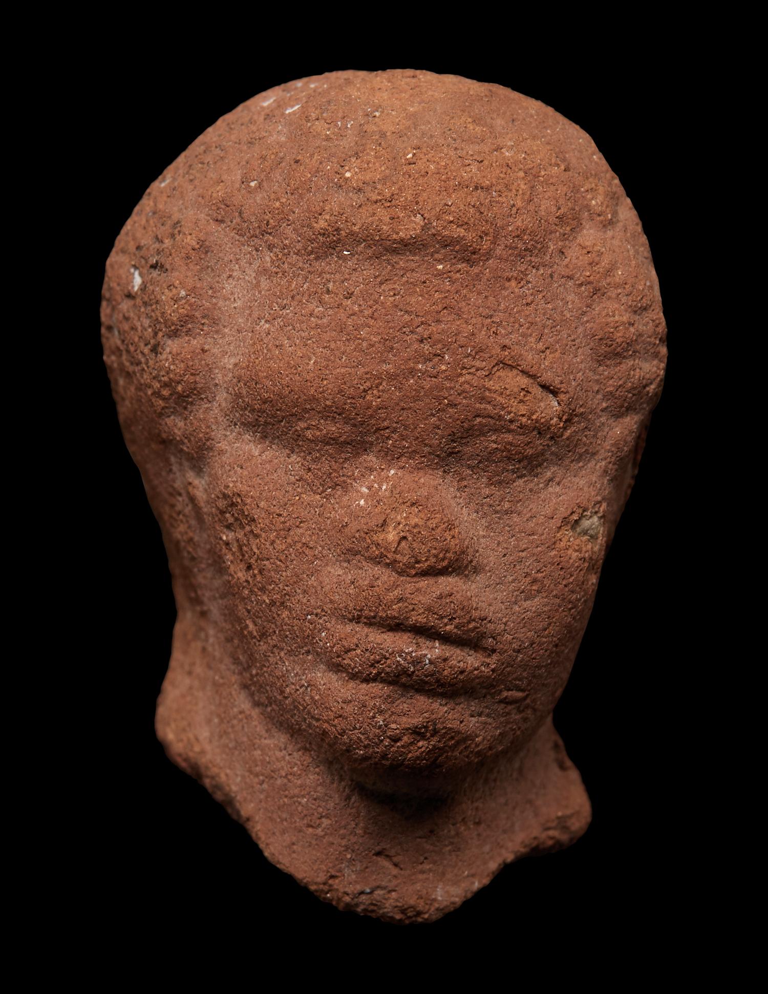 A Nubian Terracotta Head and Reclining Figure