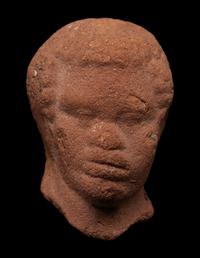 A Nubian Terracotta Head and Reclining Figure