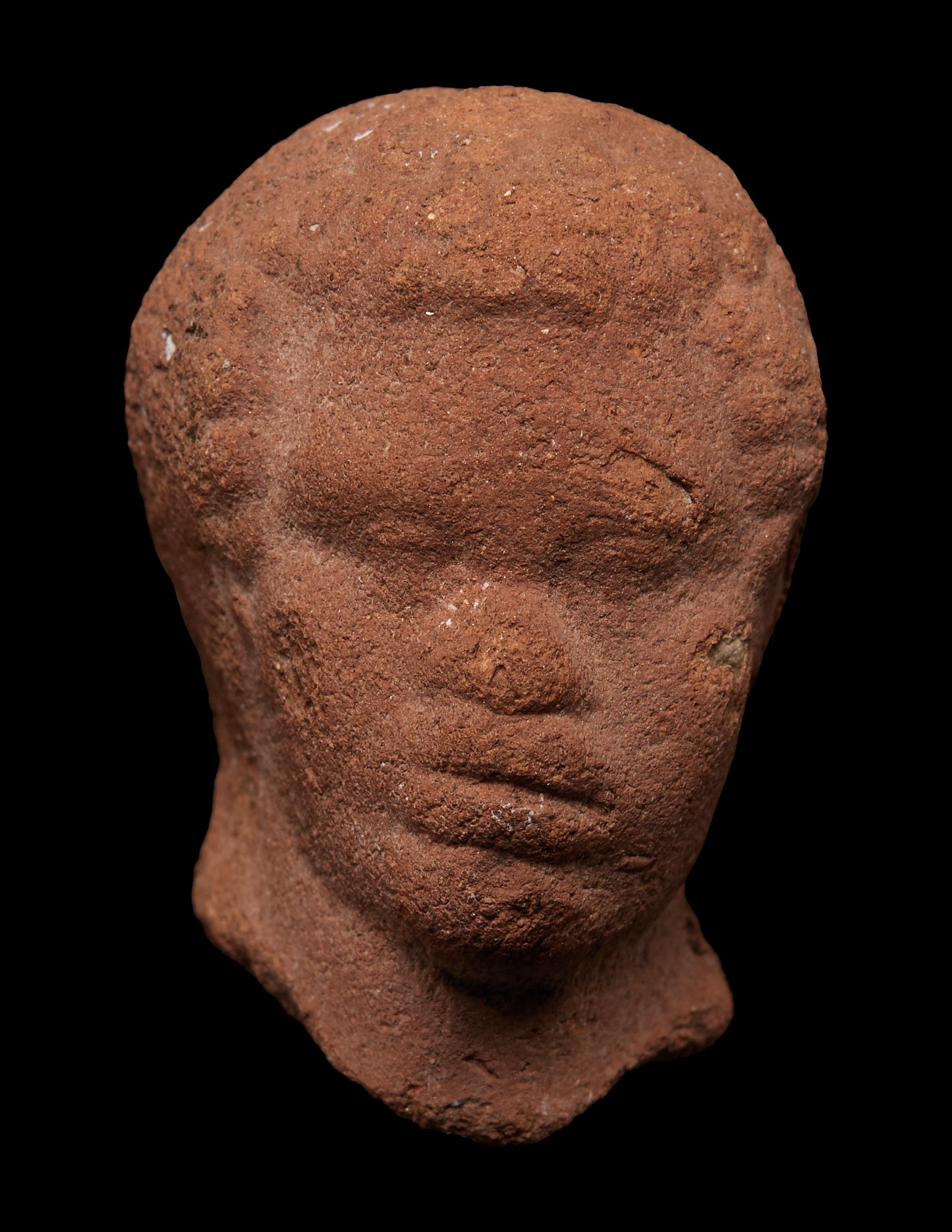 A Nubian Terracotta Head and Reclining Figure