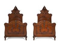 A Pair of American Victorian Carved Mahogany Twin Beds