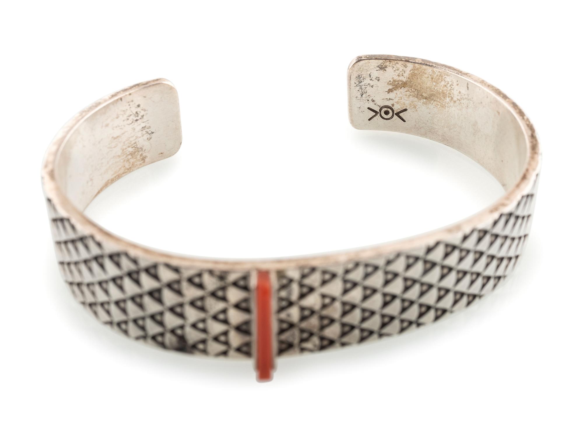 Heavily Stamped Silver Cuff Bracelet, set with a Slender Coral Sliver