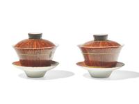 A Pair of Chinese Faux Bois Porcelain Erotic Tea Bowls, Covers, and Stands