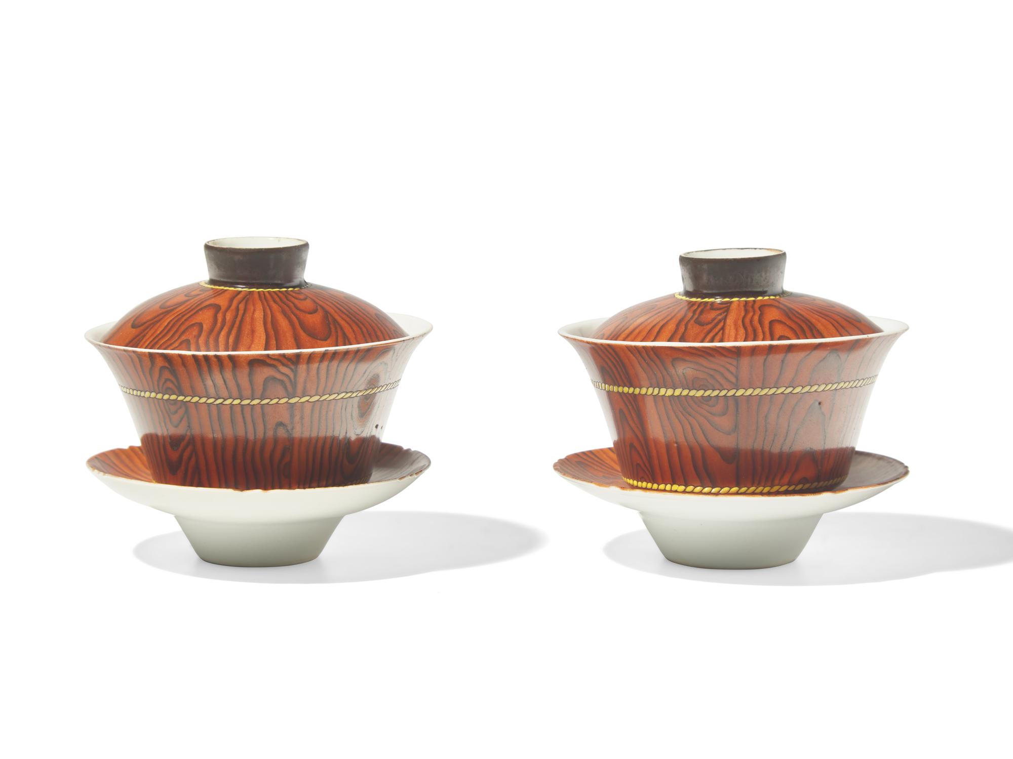 A Pair of Chinese Faux Bois Porcelain Erotic Tea Bowls, Covers, and Stands