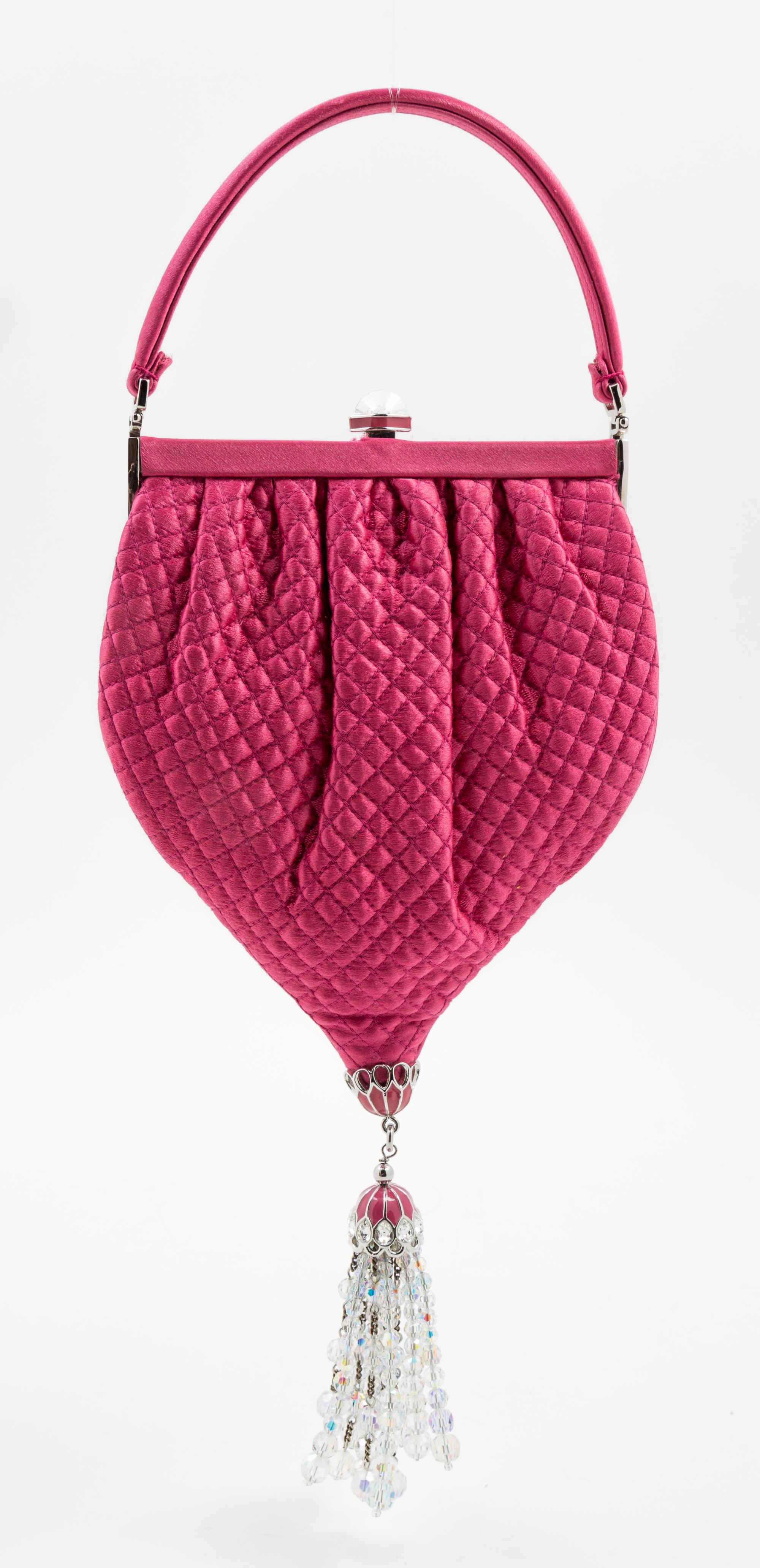 A Judith Leiber Pink Satin Quilted Handbag, 5.5" x 10" x 1"; Handle drop: 3".