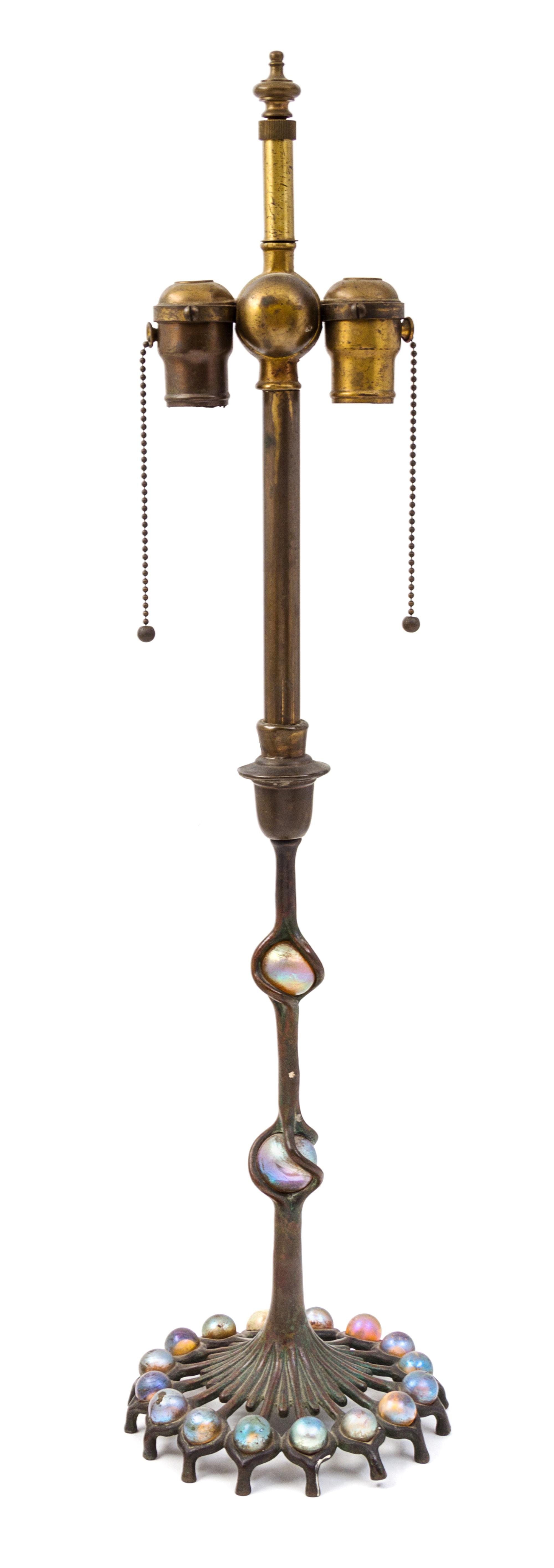 A Tiffany Studios Favrile Glass and Bronze Candlestick Height 28 inches.