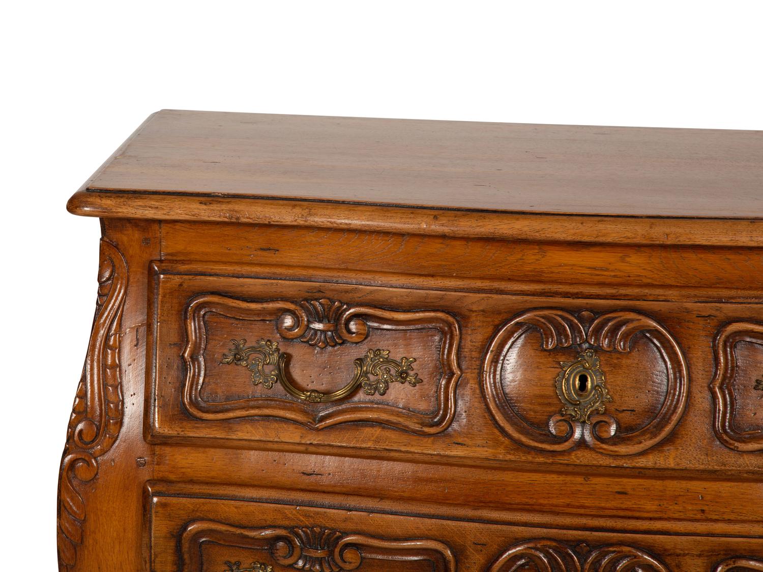 A Louis XV Provincial Style Carved Walnut Commode