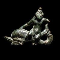 A Roman Bronze Eros Riding a Dolphin