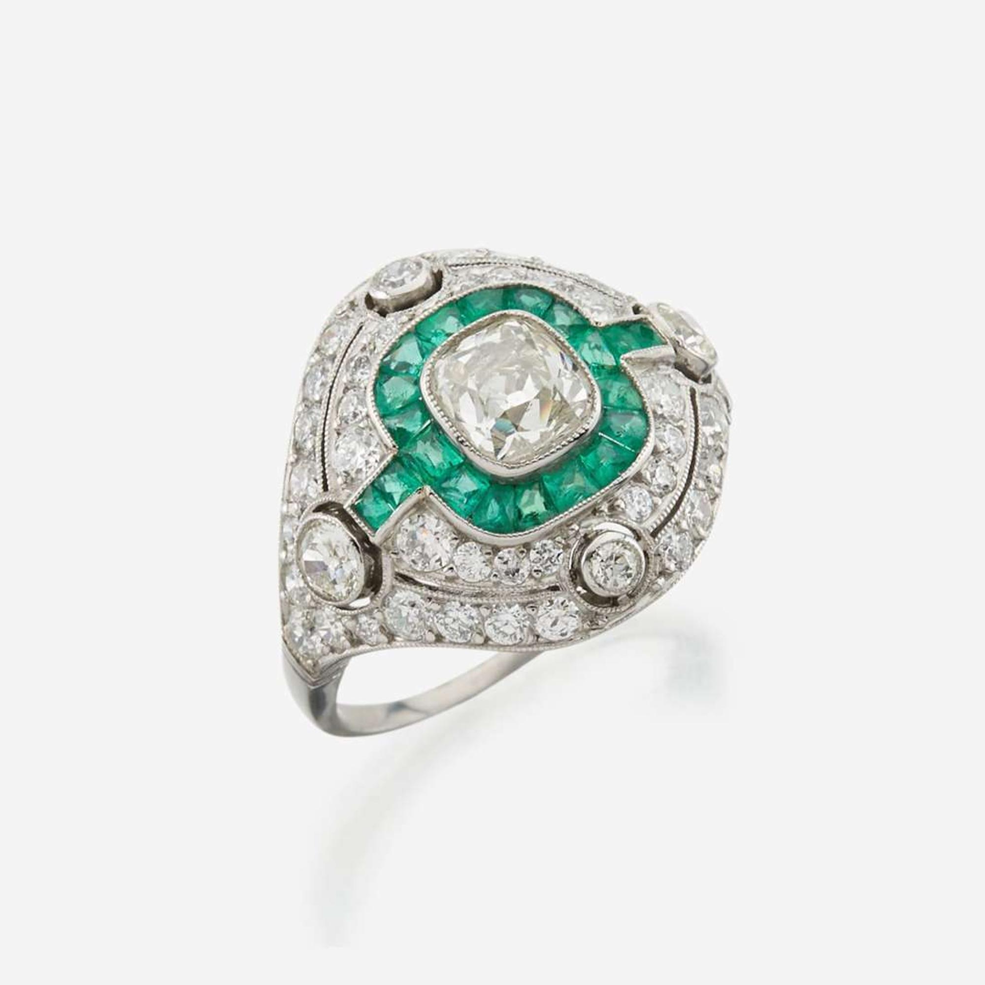 A diamond, emerald, and platinum ring