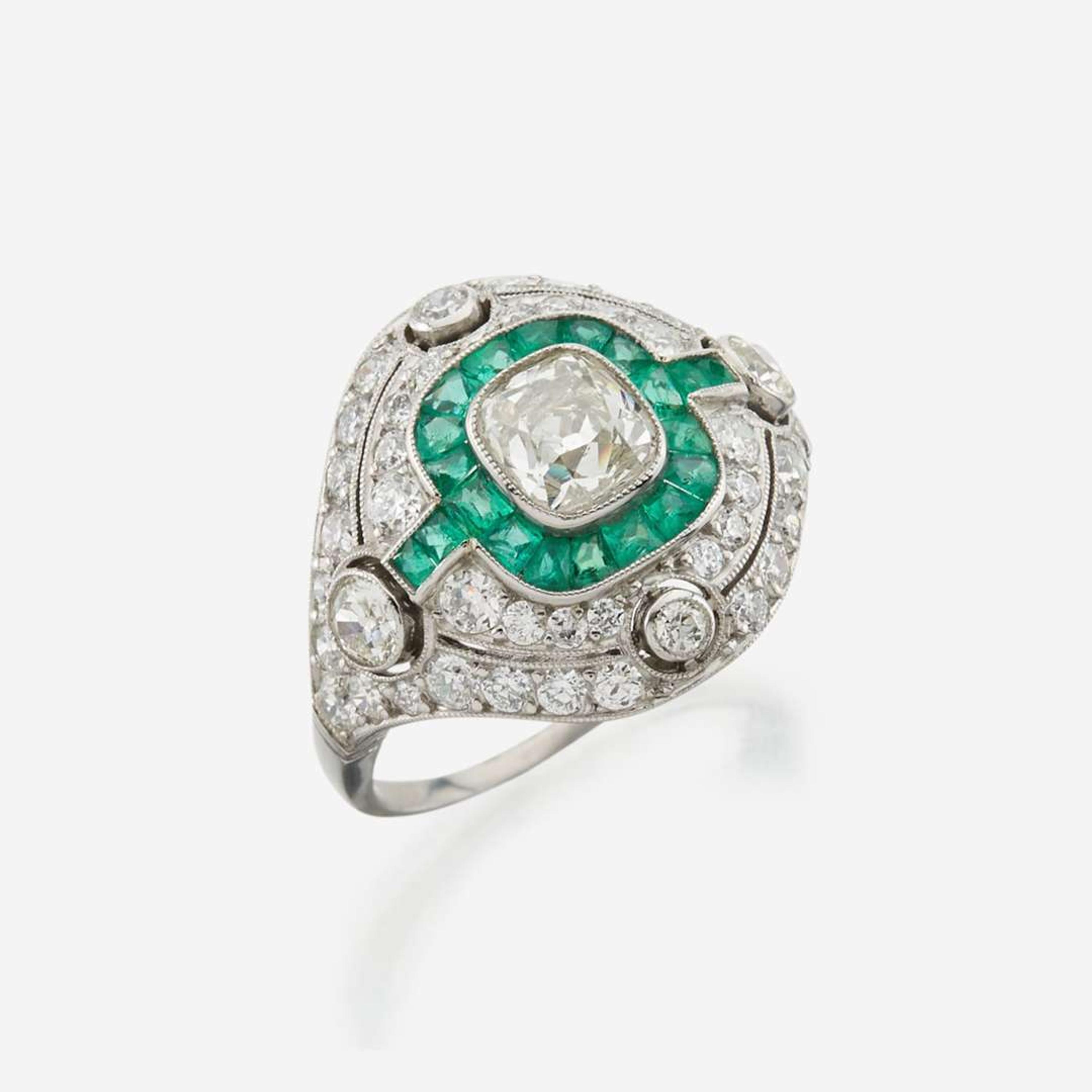 A diamond, emerald, and platinum ring