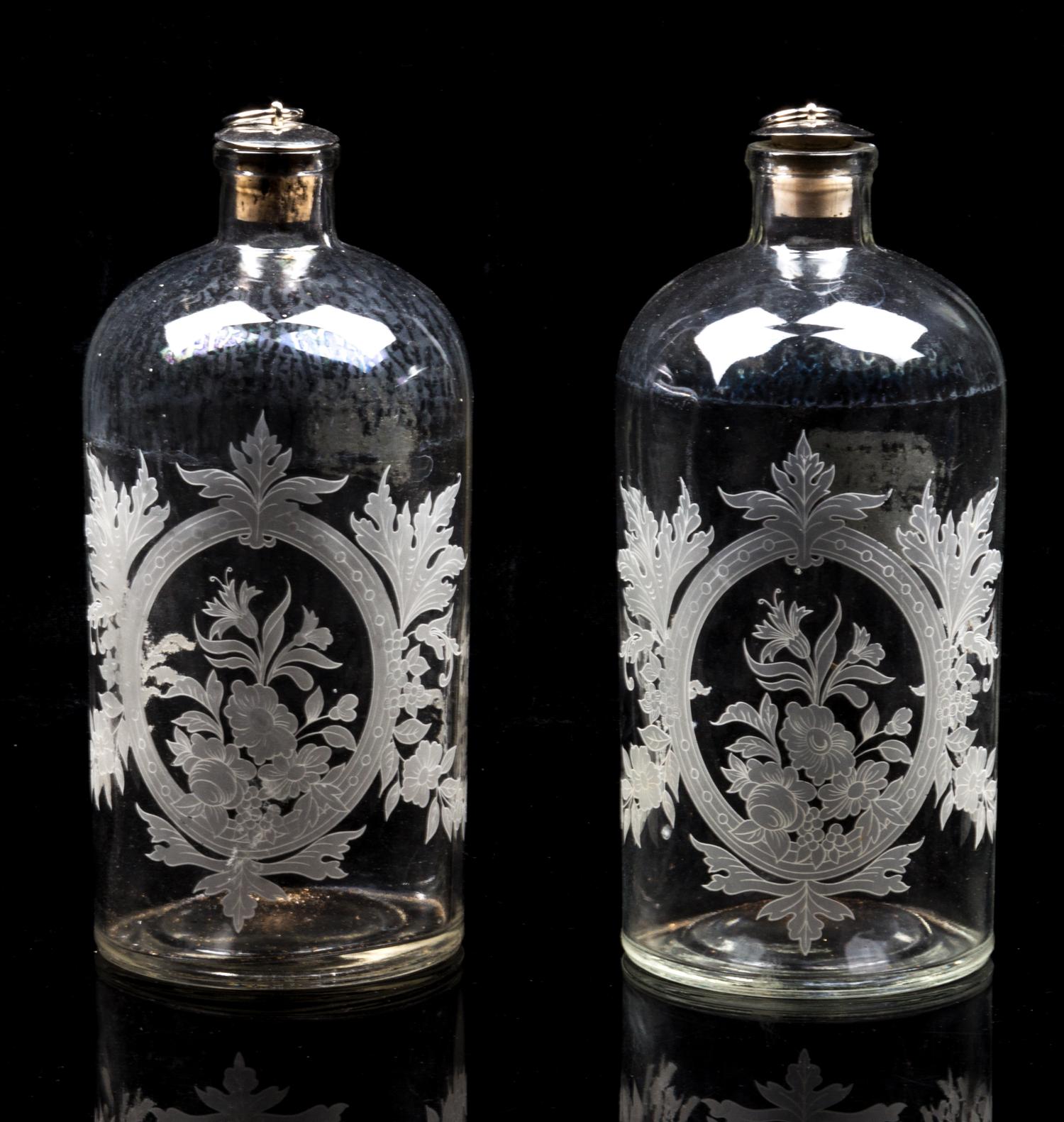 A Pair of Glass Bottles Height 8 1/4 inches.