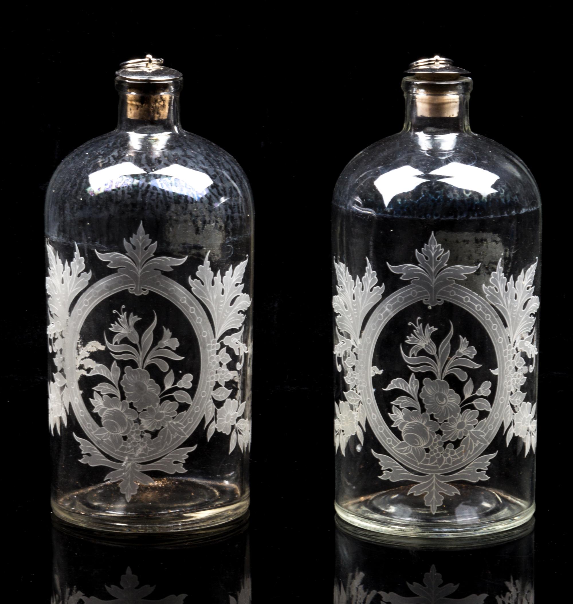 A Pair of Glass Bottles Height 8 1/4 inches.
