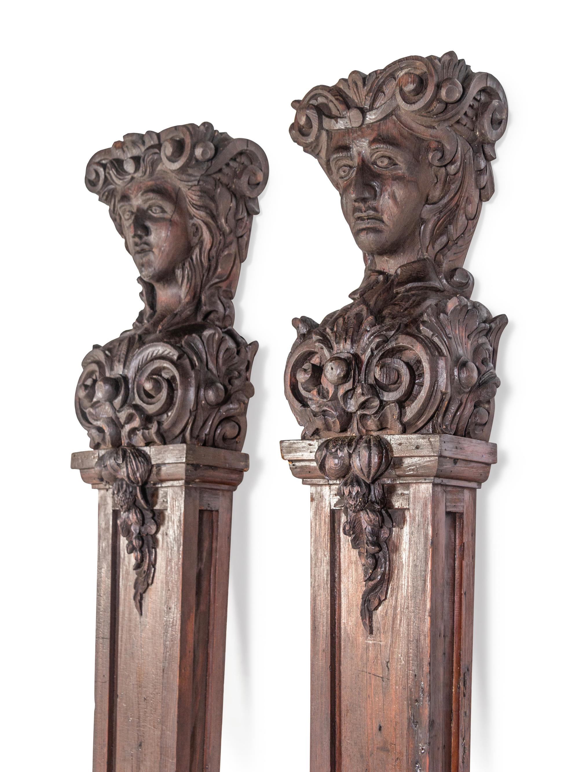 A Pair of Continental Carved Oak Figural Pilasters
