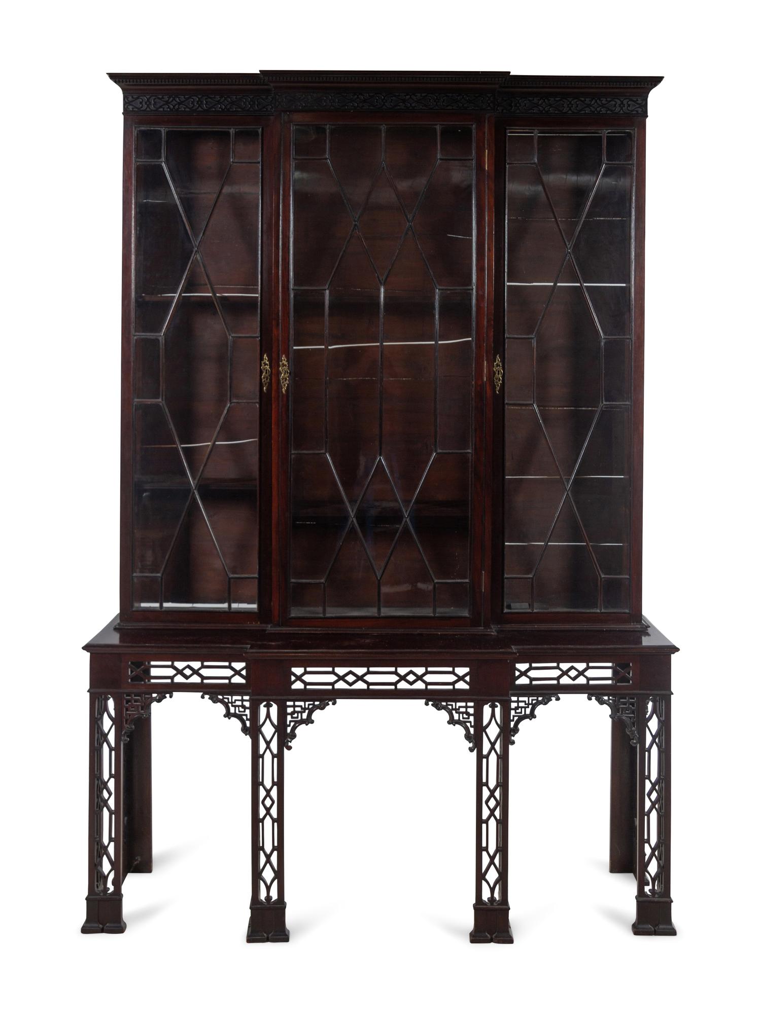 A Chinese Chippendale Pierce-Carved Mahogany Breakfront Bookcase on Stand