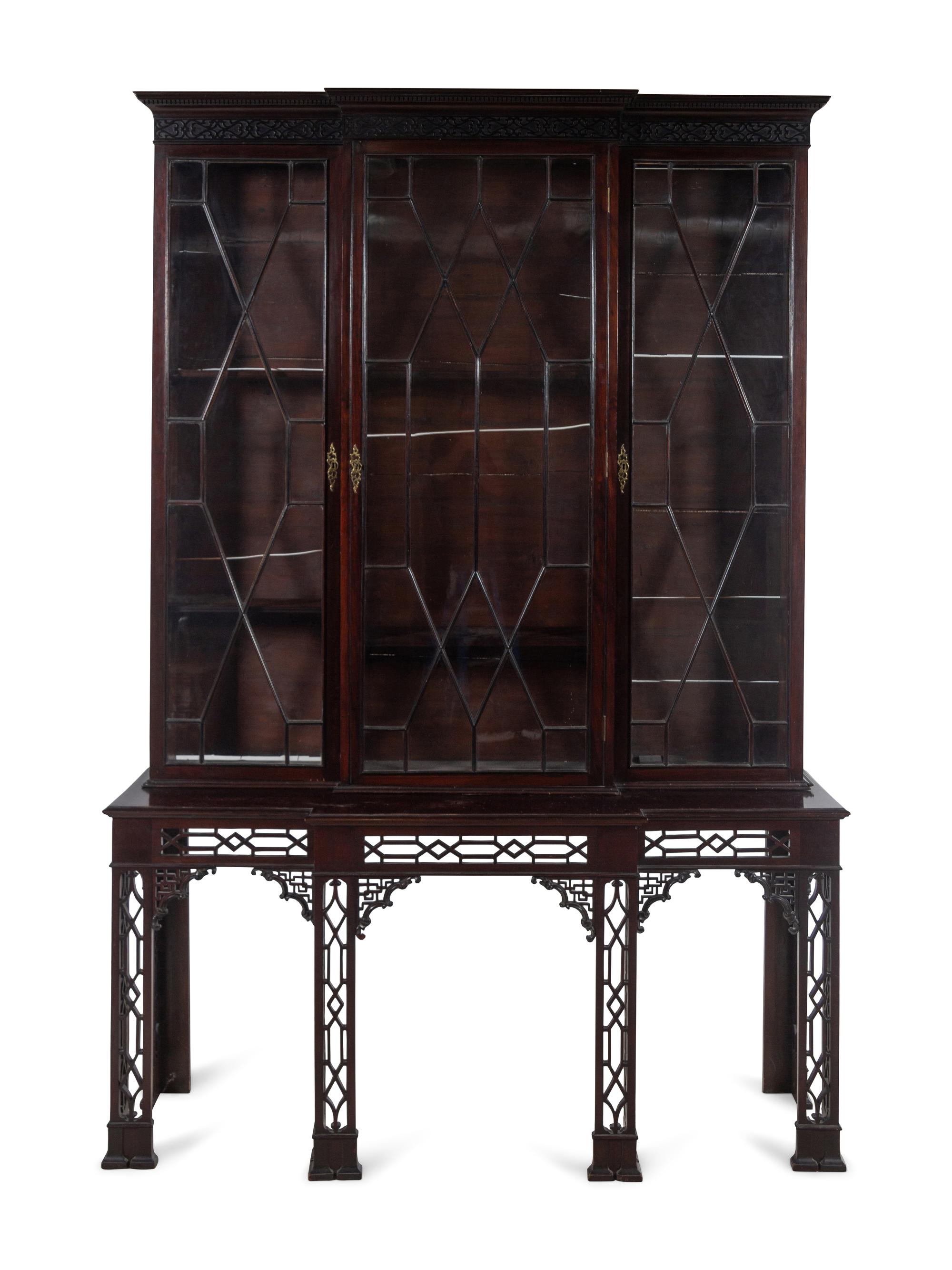 A Chinese Chippendale Pierce-Carved Mahogany Breakfront Bookcase on Stand