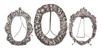 Three Silver-Plate Picture Frames, , each oval, one with a repousse border showing fruit and flowers, one with a crowned border chased