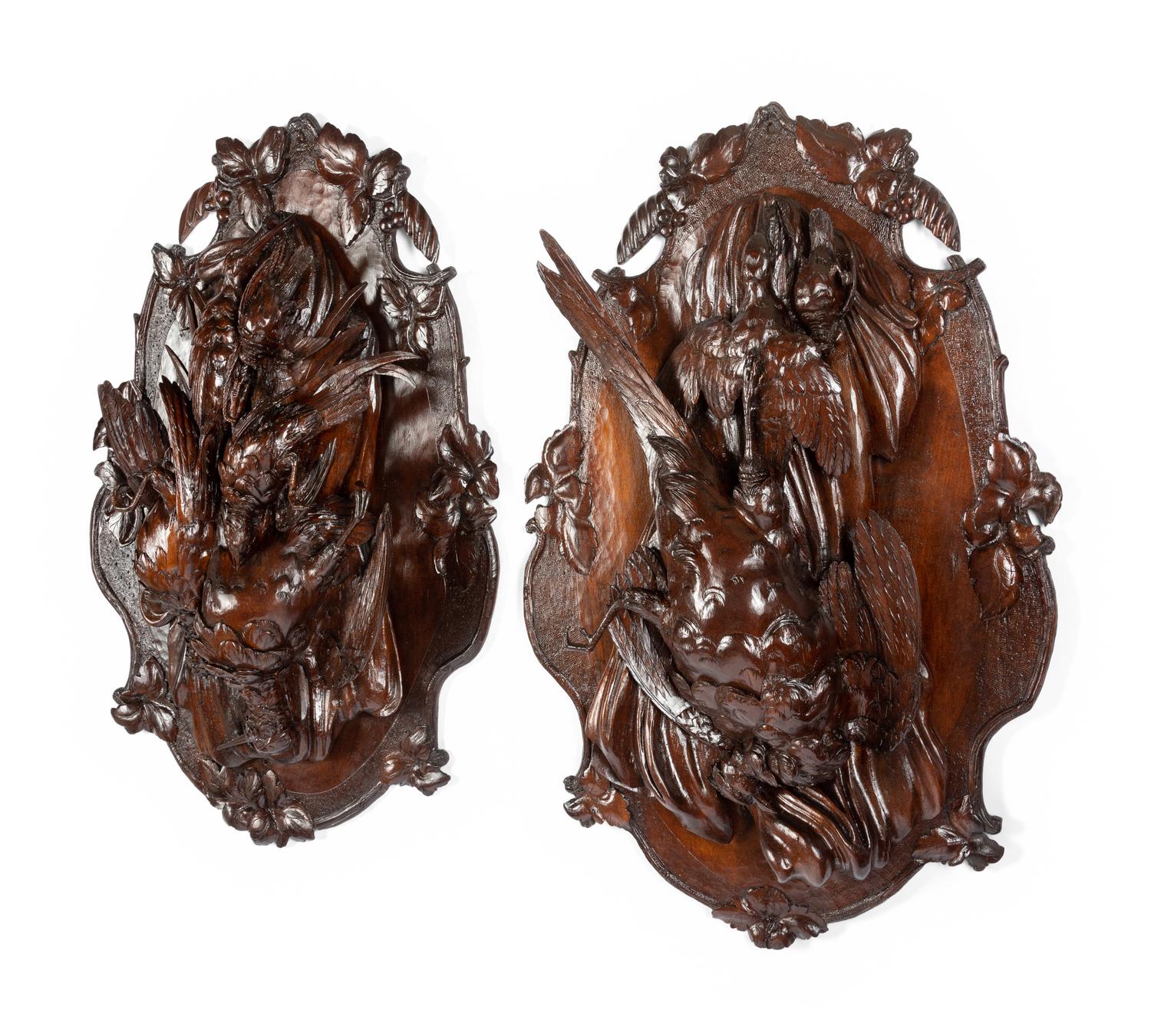 A Pair of Swiss Black Forest Carved Walnut Game Plaques