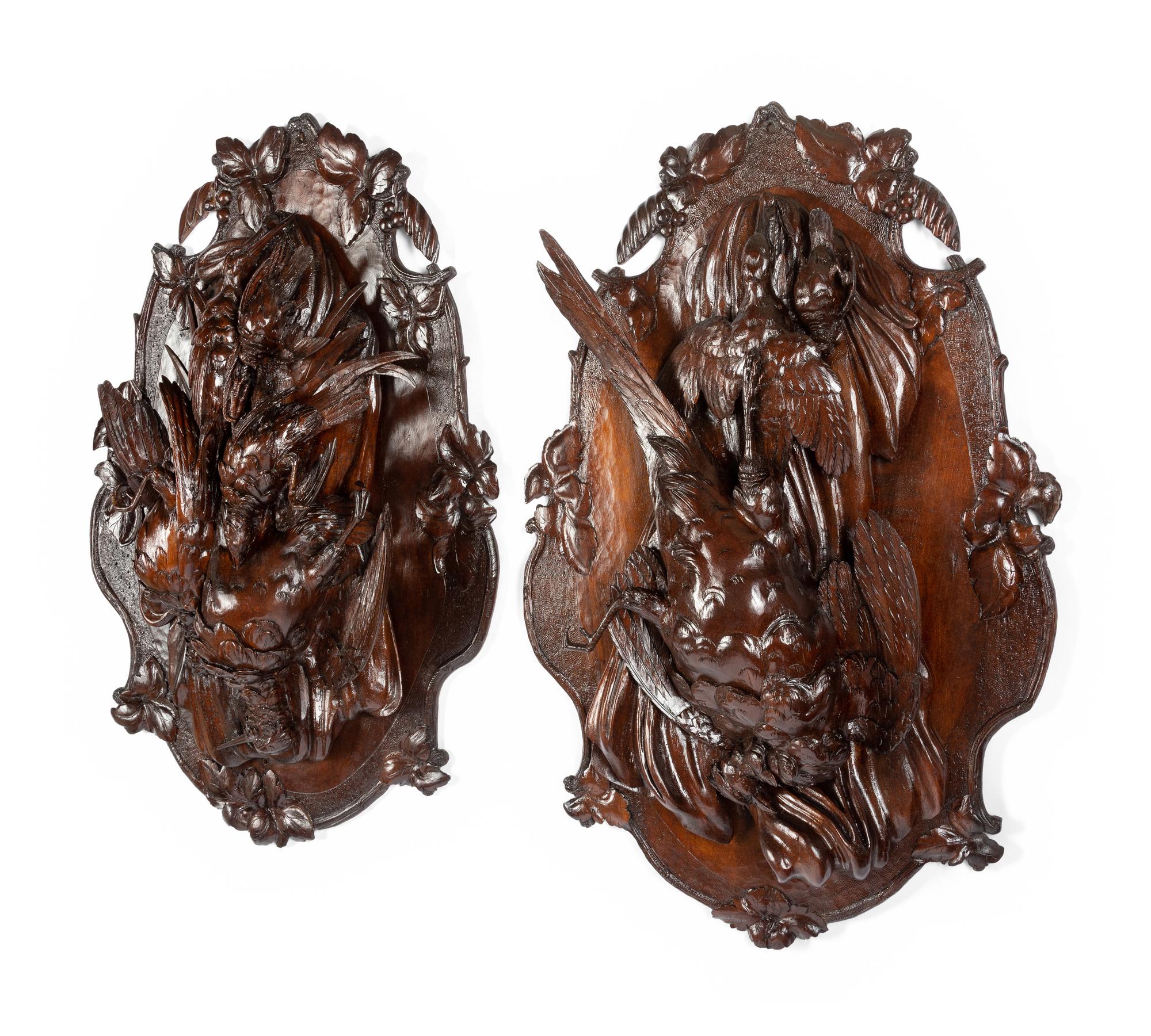 A Pair of Swiss Black Forest Carved Walnut Game Plaques