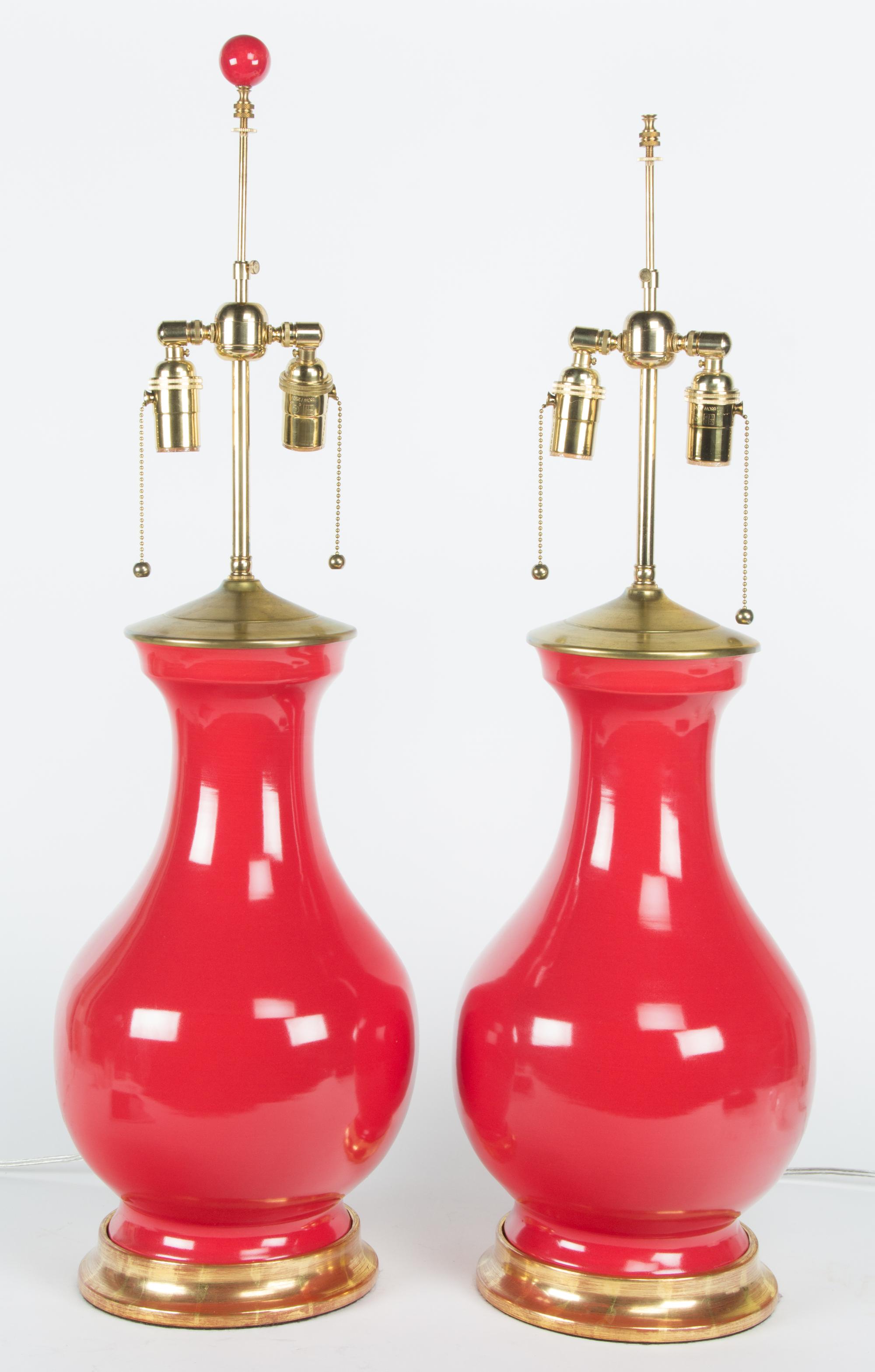 A Pair of Red Glazed Porcelain Urns Height 31 1/2 inches. — 20TH CENTURY