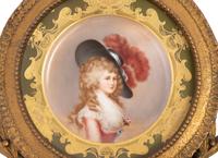 A German Porcelain Cabinet Plate in a Pierce Carved Giltwood Frame after Thomas Gainsborough (1727-1788)